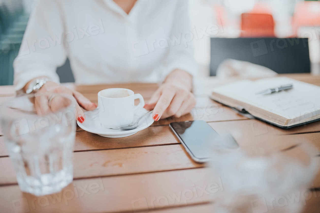 Consultant reviewing notes over coffee