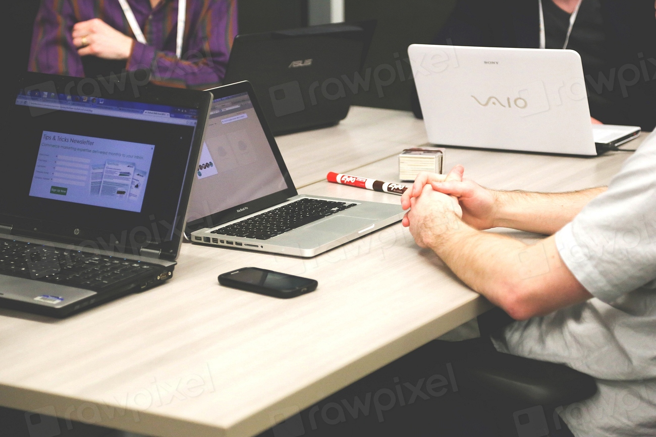 Team members meeting together with laptops open